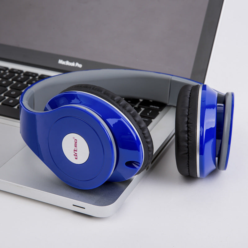 Blue wired gaming headphones resting on a laptop keyboard, showcasing stylish design and comfortable ear cushions.