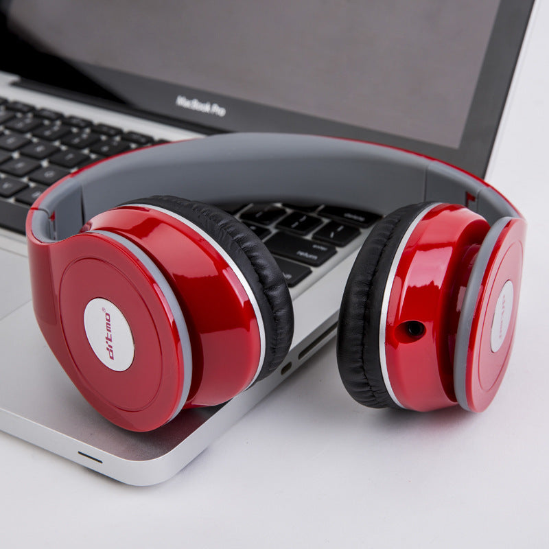 Red wired gaming headphones showcasing stylish design, comfortable ear cushions, placed on a laptop keyboard.