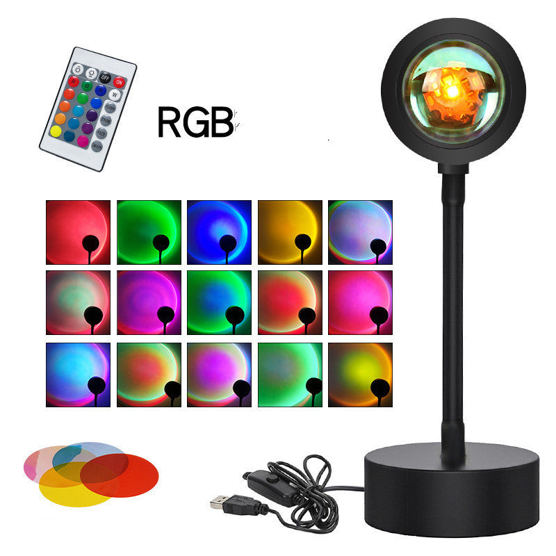 Sunset projection lamp casting warm colors, showcasing remote control and various light effects for cozy ambiance.