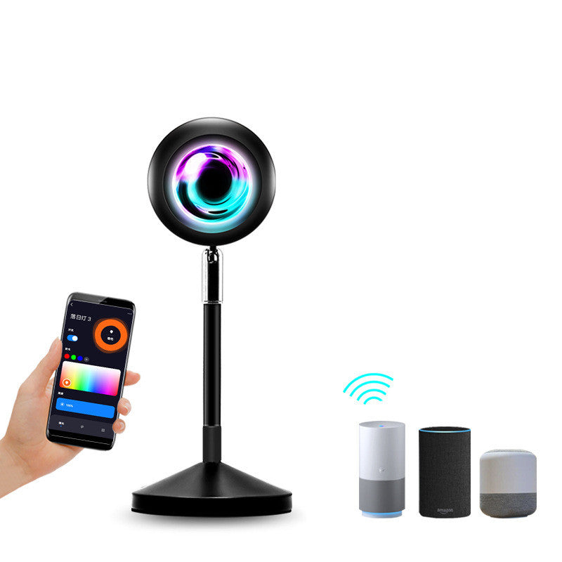Sunset projection lamp casting warm colors, showcasing remote control and various light effects for cozy ambiance.